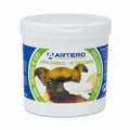 Tub of Artero disposable eye cleaning wipes being used on a dog's eye