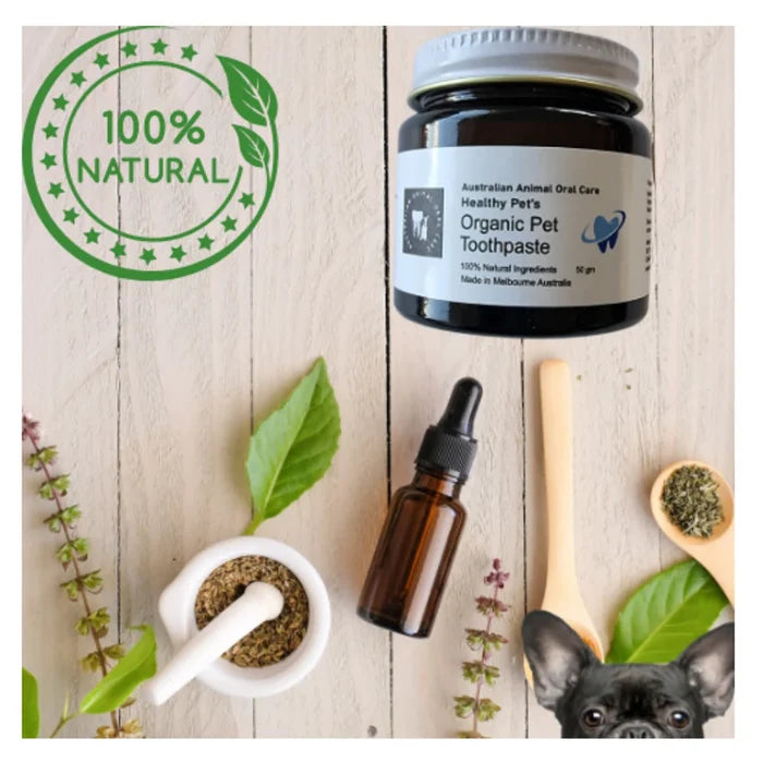 Jar of Australian Animal Oral Care Organic Pet Toothpaste surrounded by natural herbal ingredients