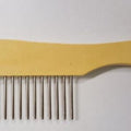 Extra wide wooden-handled grooming comb with widely spaced metal teeth