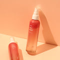Two red bottles of INOOM vegan Pet Mist grooming spray with spray nozzles