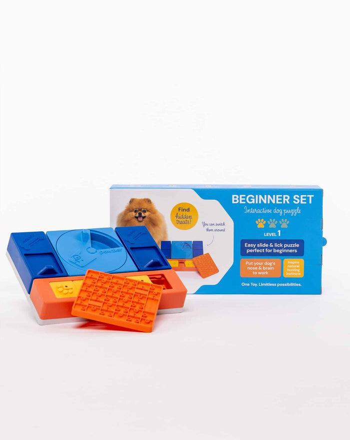 Pawzler Beginner Set box beside assembled blue and orange slide-and-lick dog puzzle