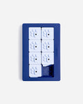 Navy blue Pawzler Louvre puzzle tray with white paw-print sliding tiles, overhead view