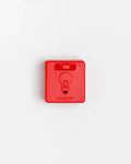 Closed red Pawzler Peach puzzle piece with lightbulb icon, top-down view