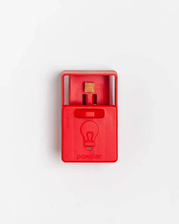 Open red Pawzler Peach puzzle piece with a treat inside its compartment