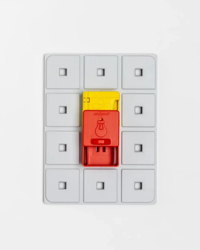 Red and yellow Pawzler Peach puzzle pieces mounted on a grey base
