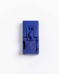 Closed navy blue Pawzler Sela puzzle piece with sliding lever and puzzle-piece icon