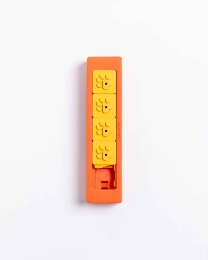 Closed orange Pawzler Zhu puzzle piece with four yellow flower-shaped tiles, top-down view