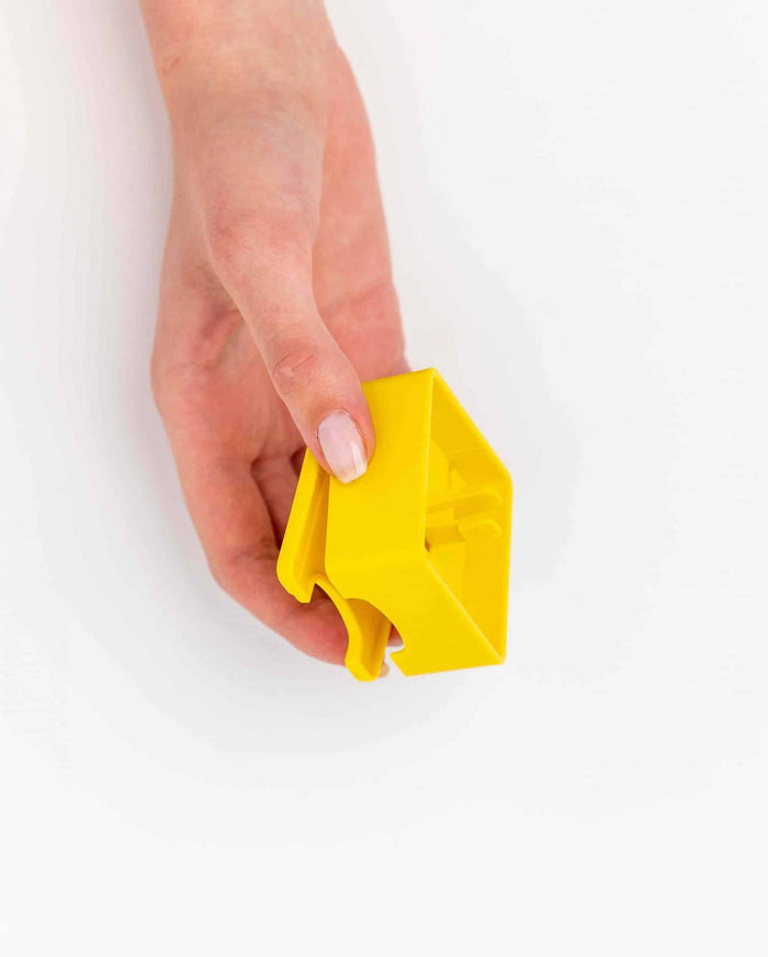 Hand holding the yellow Pawzler Zoey puzzle piece
