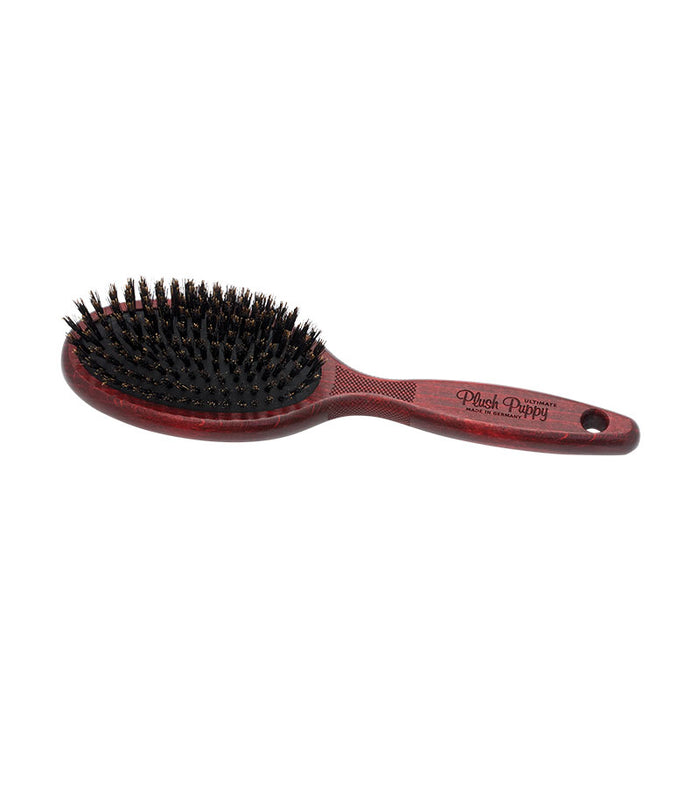 Plush Puppy Ultimate Pure Boar Bristle Brush with dark red wooden handle, angled view