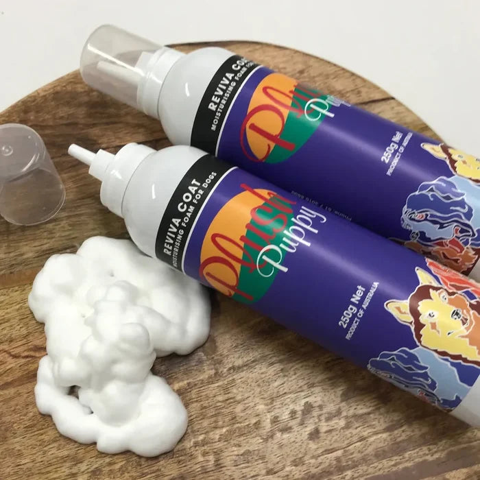 Two cans of Plush Puppy Reviva Coat Moisturising Foam beside a dollop of white foam