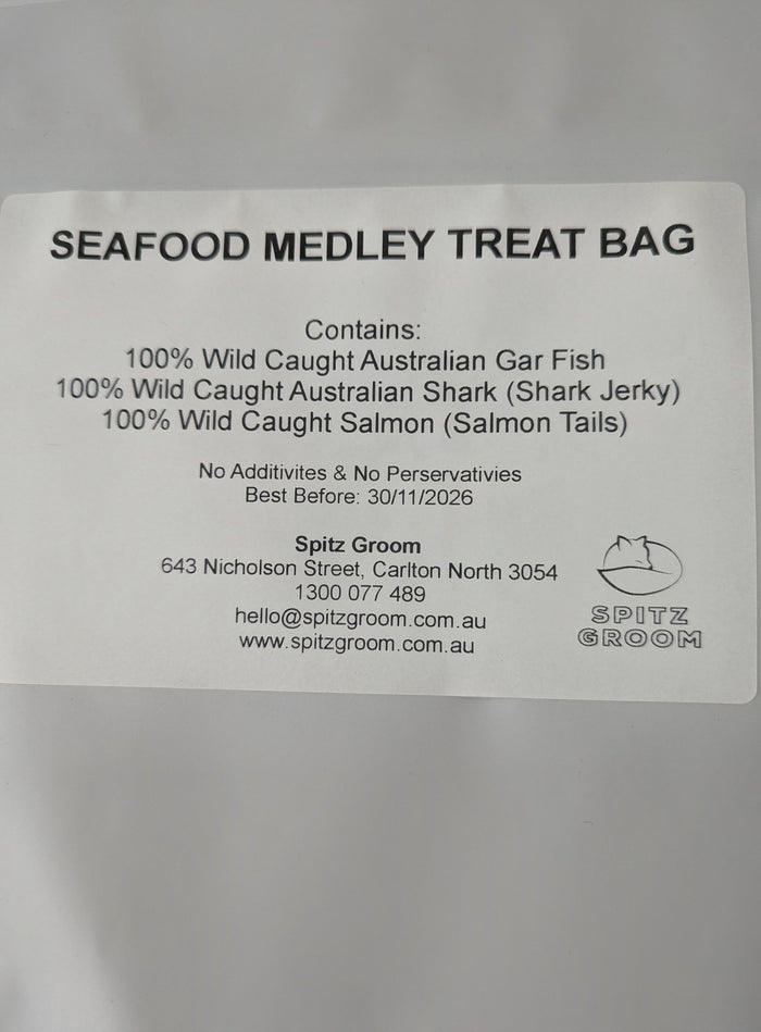 Close-up of ingredient label on Seafood Medley dog treat bag listing gar fish, shark and salmon