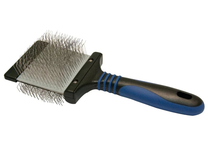 Show Tech Twin Flex Slicker brush with wire pin head and blue/black handle, angled view