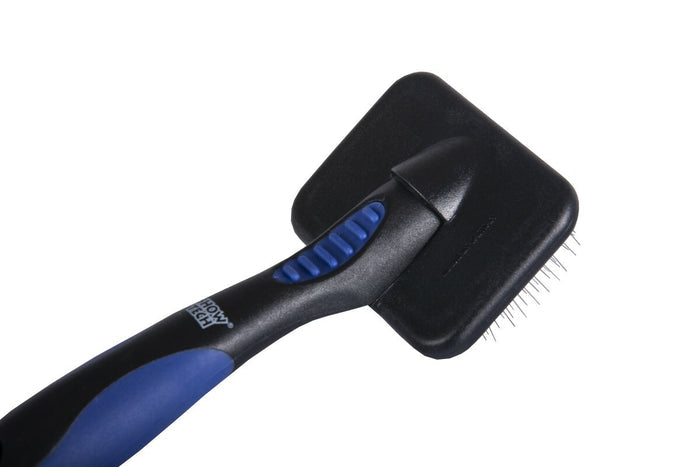 Close-up of the folded protective guard over a Show Tech tiny slicker brush's pins