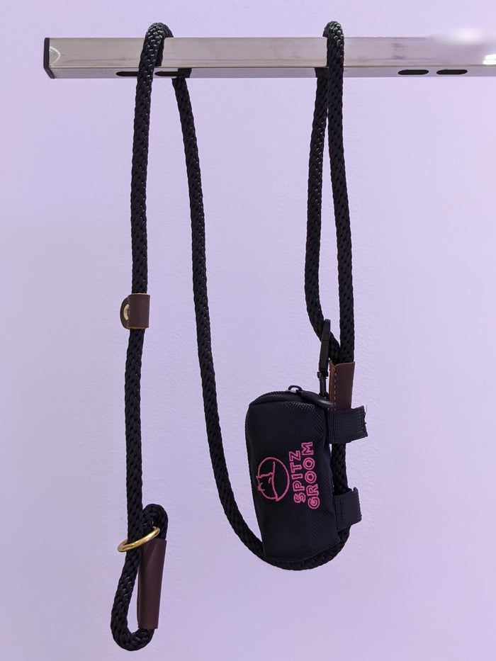 Black rope lead hanging with the Spitz Groom poo bag holder pouch attached