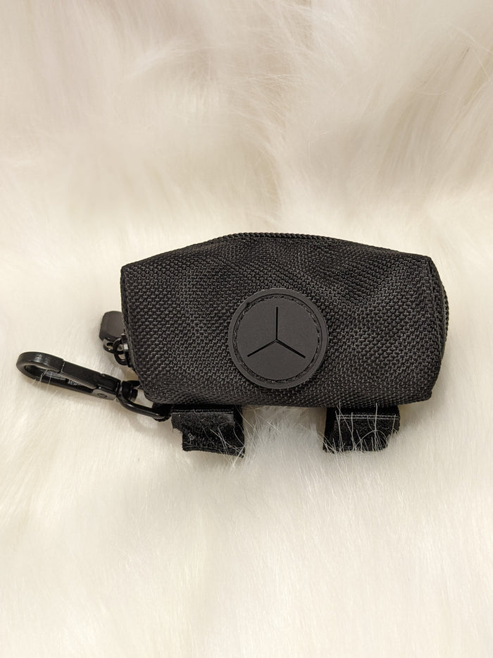 Black treat holder pouch with circular emblem badge and clip hook